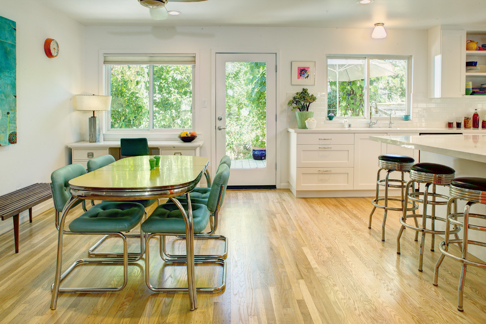 Eclectic kitchen/dining combo in Sacramento with white walls and light hardwood floors.