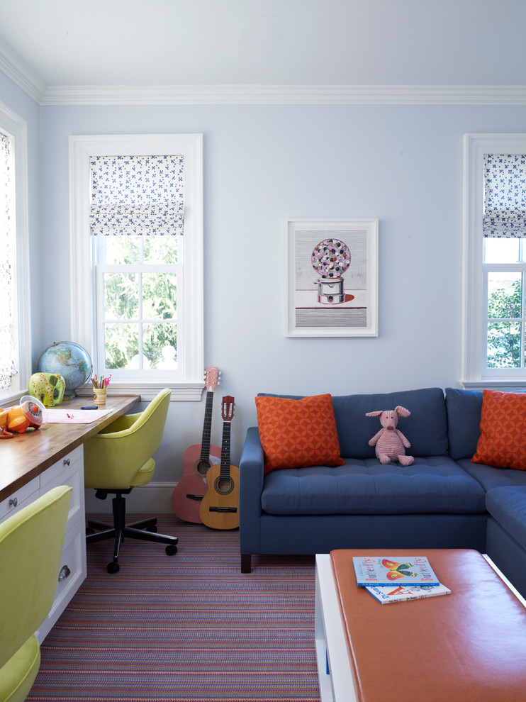 Transitional kids' study room in New York with blue walls and carpet.