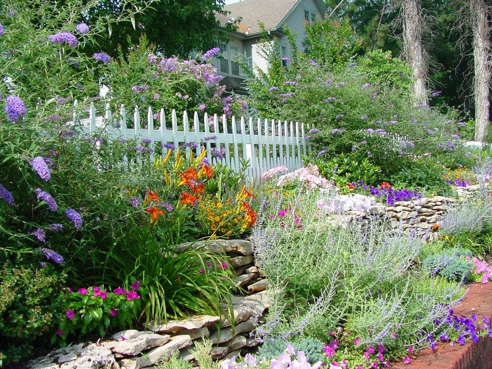 This is an example of a traditional sloped full sun garden in Other.