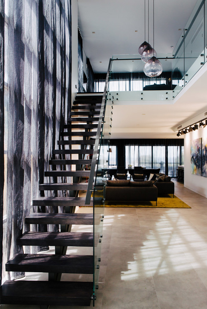 Contemporary wood straight staircase in Sydney with open risers and glass railing.