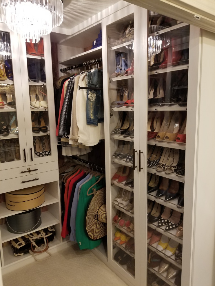 Small classic walk-in wardrobe for women in Orange County with shaker cabinets and white cabinets.