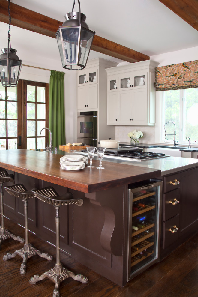Large transitional galley medium tone wood floor eat-in kitchen photo in Atlanta with a farmhouse sink, white backsplash, stainless steel appliances and an island