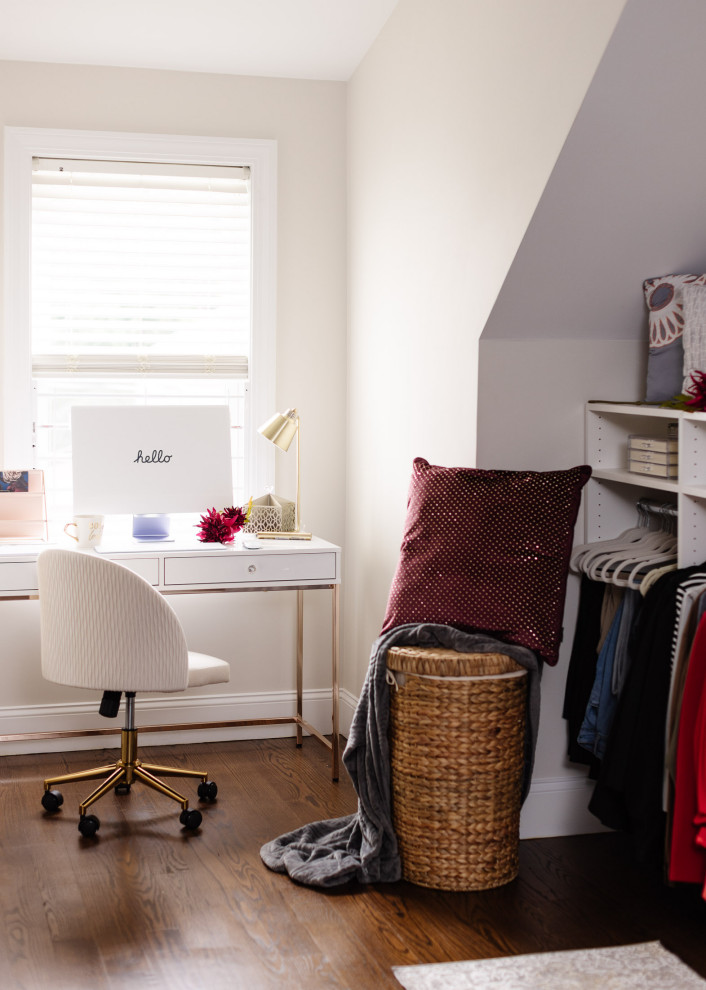 This is an example of a small modern walk-in wardrobe for women in Boston with shaker cabinets, white cabinets, dark hardwood flooring and brown floors.