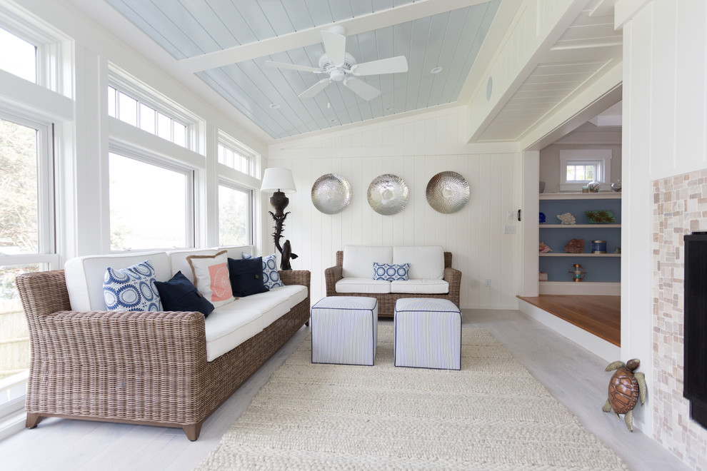 Mid-sized beach style sunroom in Boston with light hardwood floors, a two-sided fireplace, a tile fireplace surround and a standard ceiling.