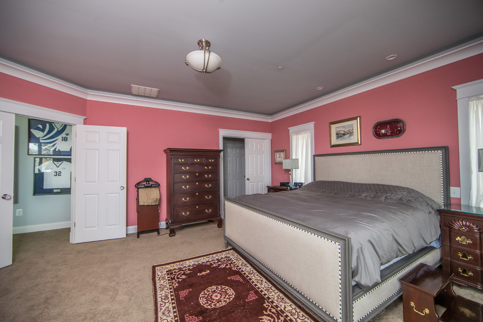 This is an example of a mid-sized traditional guest bedroom in DC Metro with pink walls, carpet, no fireplace and beige floor.