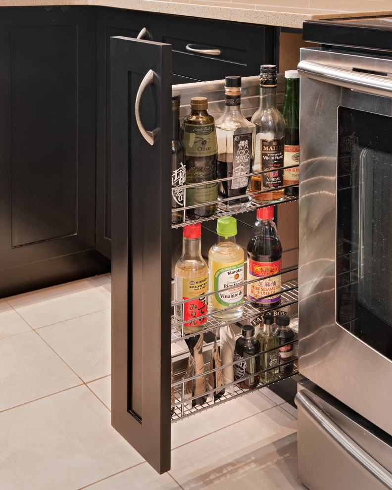 Home design - mid-sized transitional u-shaped ceramic tile home design idea in Ottawa with an undermount sink, shaker cabinets, black cabinets, quartz countertops, beige backsplash, glass tile backsplash, stainless steel appliances and a peninsula