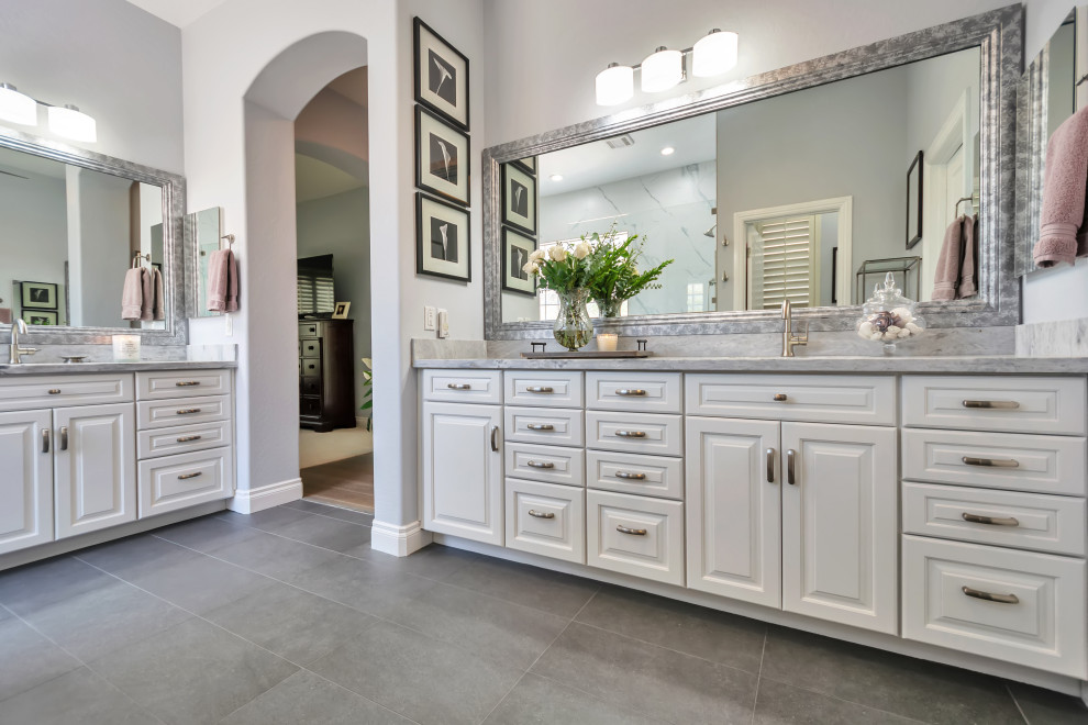 Mid-sized transitional master bathroom in Phoenix with raised-panel cabinets, white cabinets, an open shower, white tile, porcelain tile, purple walls, porcelain floors, an undermount sink, marble benchtops, grey floor, an open shower, white benchtops, a shower seat, a double vanity and a built-in vanity.