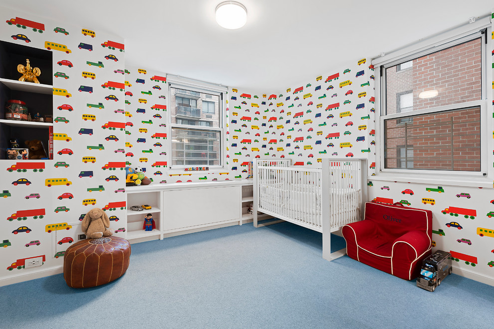 Mid-sized transitional nursery in New York with carpet, blue floor and multi-coloured walls for boys.