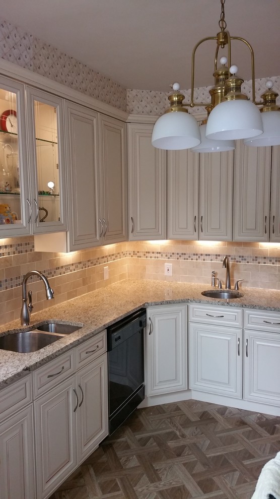 Inspiration for a small traditional l-shaped separate kitchen in Baltimore with an undermount sink, raised-panel cabinets, white cabinets, granite benchtops, beige splashback, ceramic splashback, black appliances, medium hardwood floors and brown floor.