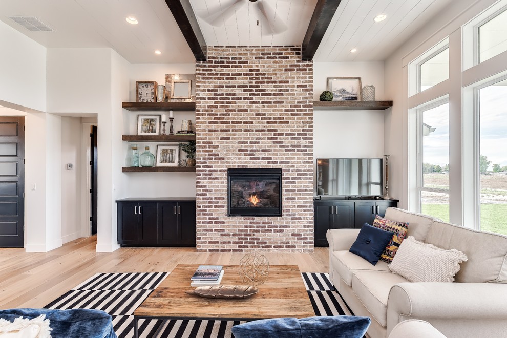 Inspiration for a contemporary living room in Boise with light hardwood floors, a standard fireplace and a brick fireplace surround.