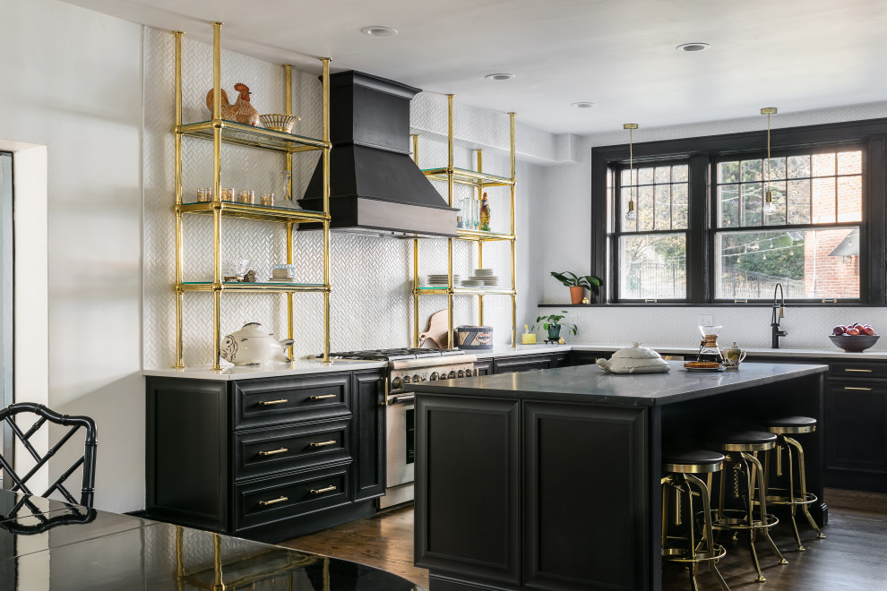 Design ideas for a traditional l-shaped eat-in kitchen in St Louis with a single-bowl sink, raised-panel cabinets, black cabinets, soapstone benchtops, white splashback, ceramic splashback, stainless steel appliances, medium hardwood floors, with island, brown floor and black benchtop.