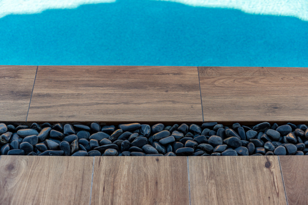 Example of a small backyard tile and rectangular pool design in Phoenix