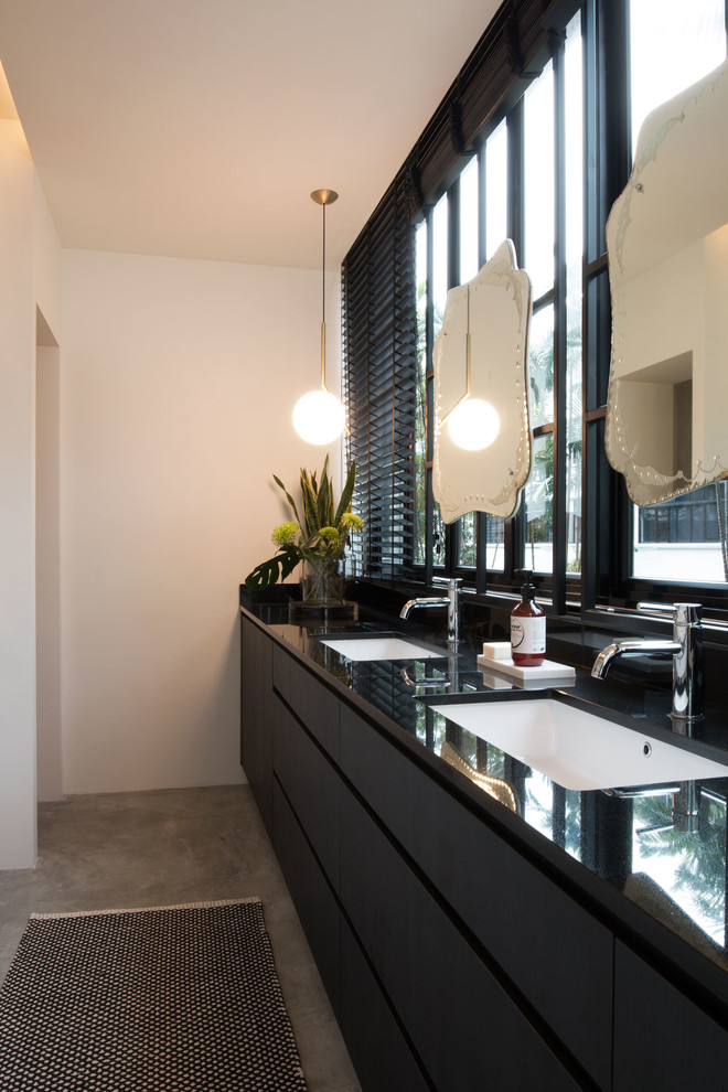 Mid-sized contemporary master bathroom in Singapore with beaded inset cabinets, white cabinets, a curbless shower, a wall-mount toilet, gray tile, cement tile, white walls, concrete floors, an undermount sink and granite benchtops.