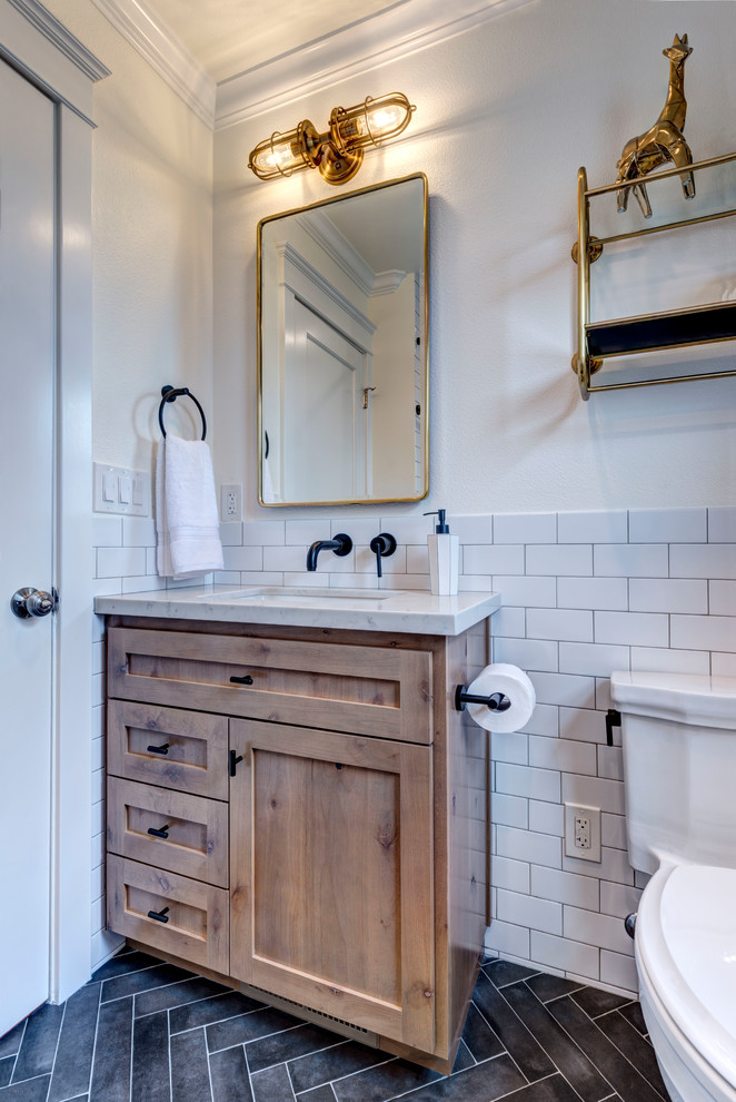 Example of a small country kids' white tile and porcelain tile porcelain tile and black floor bathroom design in San Francisco with shaker cabinets, medium tone wood cabinets, a two-piece toilet, white walls, an undermount sink, quartz countertops and white countertops