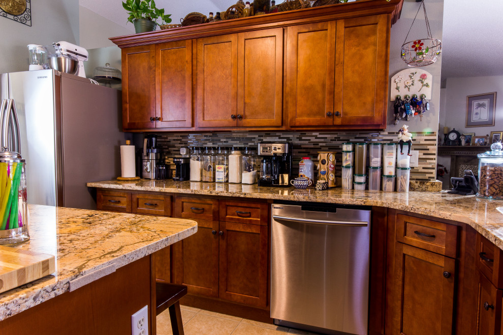 Example of a mid-sized galley cement tile floor and beige floor eat-in kitchen design with an undermount sink, shaker cabinets, medium tone wood cabinets, granite countertops, multicolored backsplash, glass sheet backsplash, stainless steel appliances, an island and beige countertops