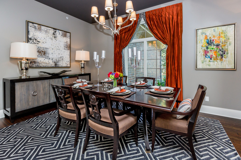 This is an example of a transitional dining room in Other with grey walls and dark hardwood floors.
