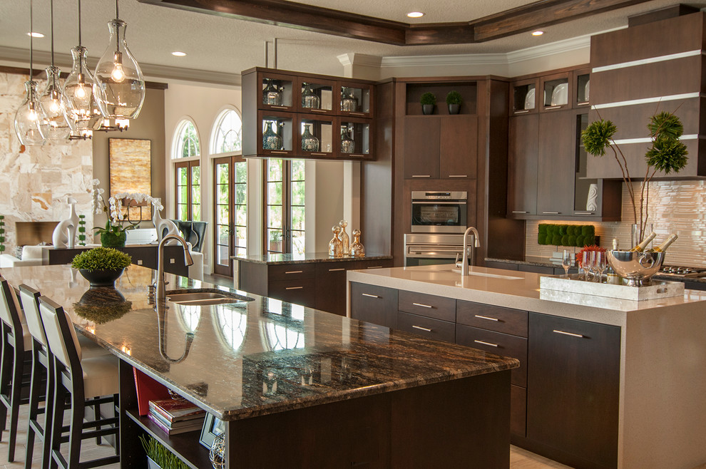 Photo of a transitional kitchen in Orlando with flat-panel cabinets, brown cabinets, glass sheet splashback and multiple islands.