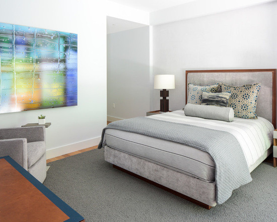 Mid-sized modern master bedroom in New York with white walls, light hardwood floors and no fireplace.