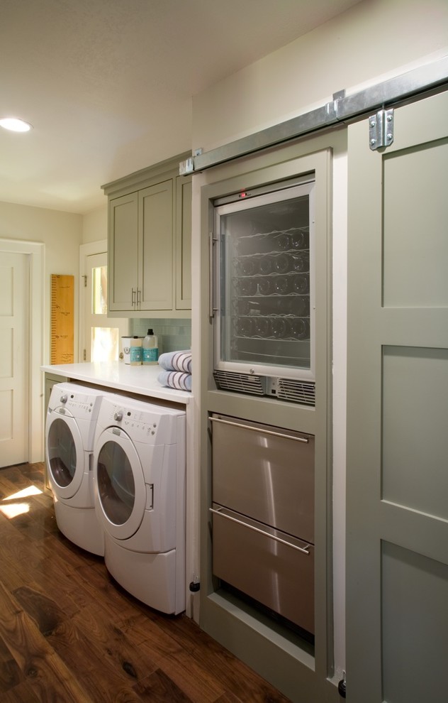 This is an example of a traditional laundry room in San Francisco with green cabinets.