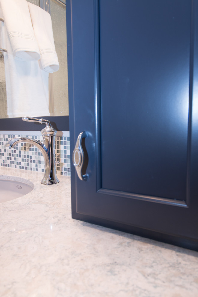 Photo of a small traditional 3/4 bathroom in Other with flat-panel cabinets, blue cabinets, a two-piece toilet, white tile, subway tile, blue walls, vinyl floors, an undermount sink and engineered quartz benchtops.