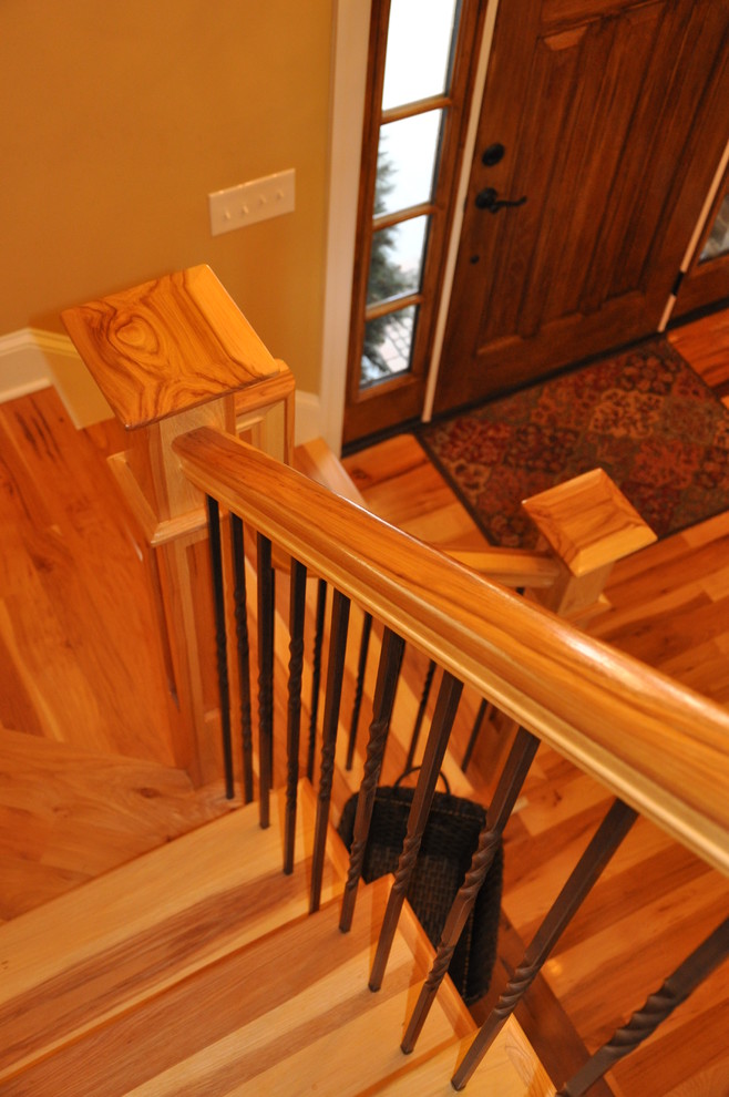 Photo of a large traditional wood l-shaped staircase in Charlotte with wood risers.