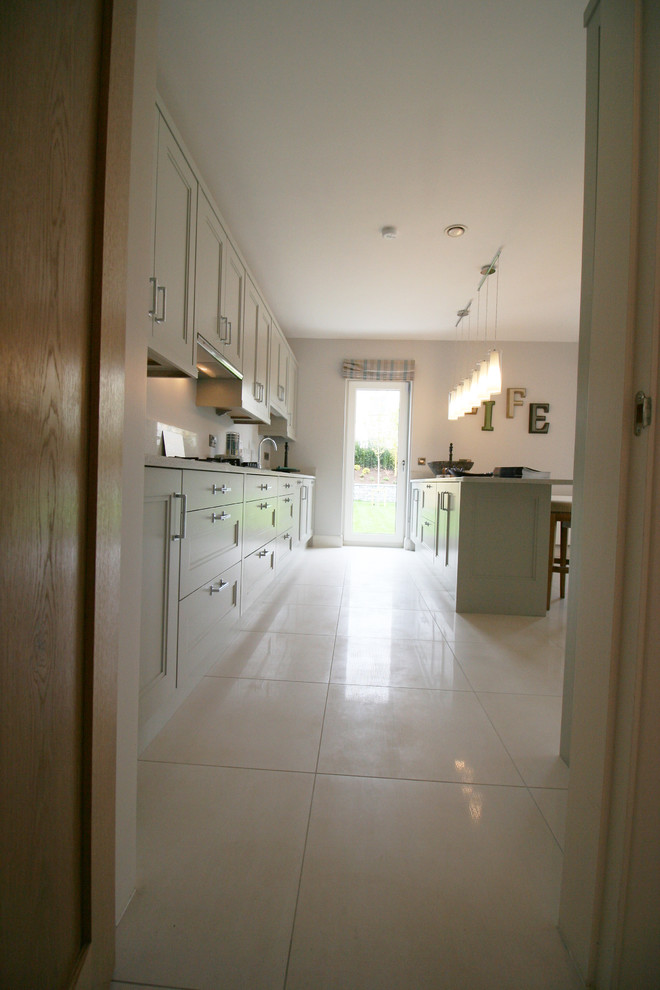Inspiration for a large modern u-shaped kitchen/diner in Dublin with beaded cabinets, white cabinets, granite worktops, porcelain flooring and no island.