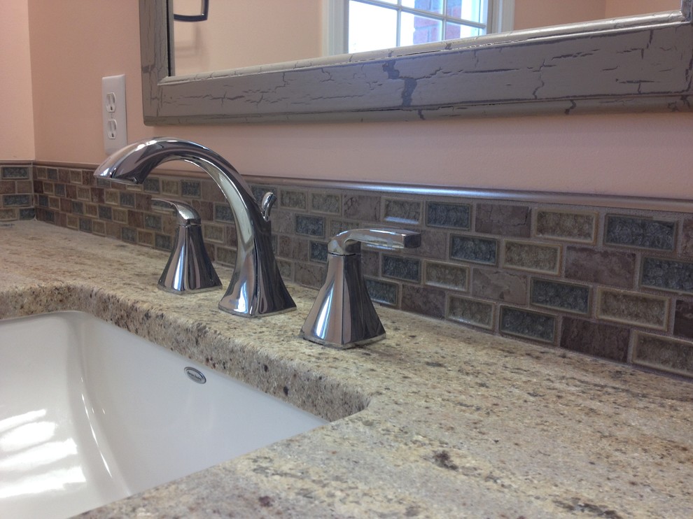 Inspiration for a mid-sized transitional gray tile and porcelain tile porcelain tile alcove bathtub remodel with an undermount sink, raised-panel cabinets, white cabinets, granite countertops and orange walls
