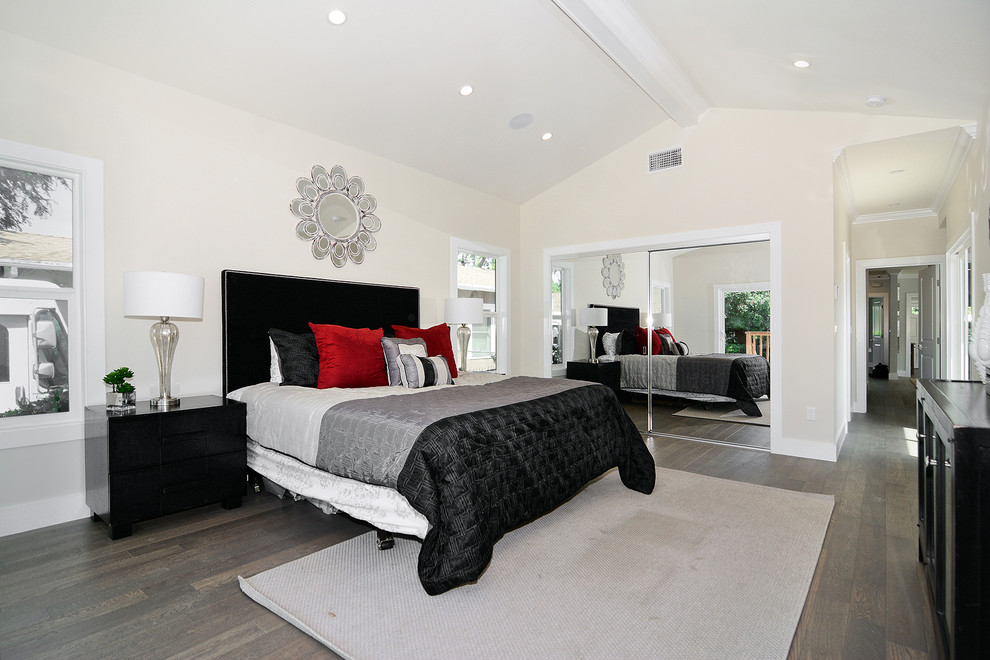 Mid-sized transitional master bedroom in Los Angeles with beige walls and dark hardwood floors.