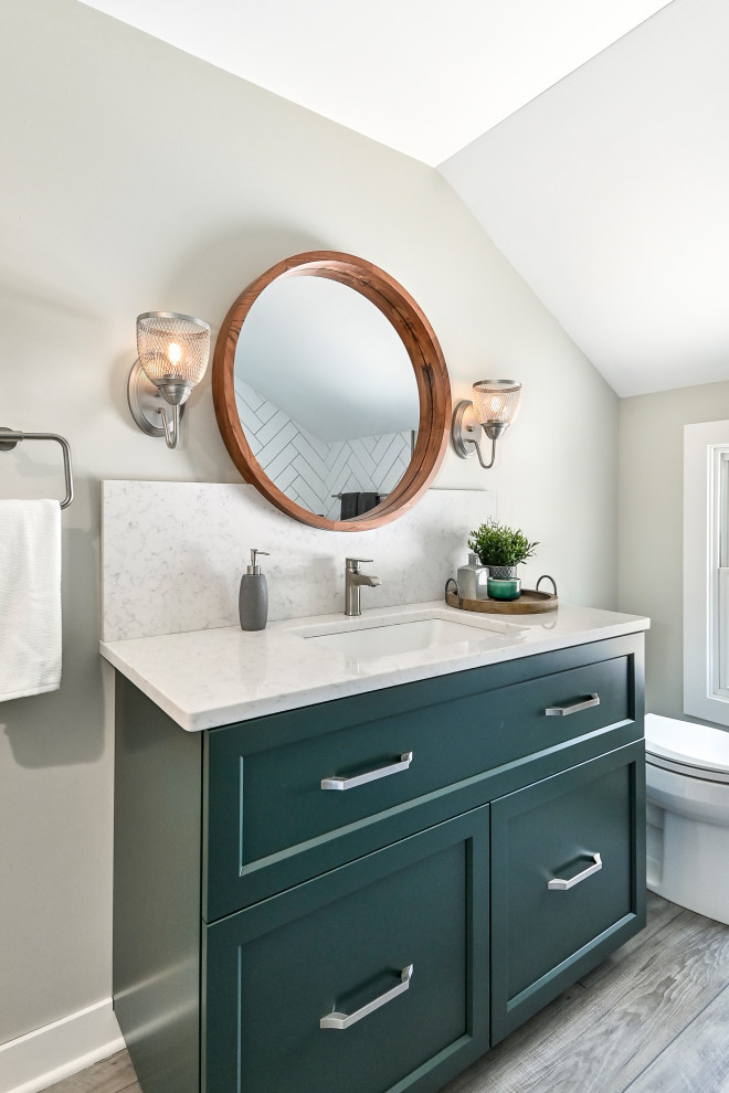 Photo of a small contemporary master bathroom in Milwaukee with shaker cabinets, green cabinets, a drop-in tub, a corner shower, a two-piece toilet, white tile, porcelain tile, beige walls, vinyl floors, an undermount sink, engineered quartz benchtops, brown floor, a hinged shower door, white benchtops, a shower seat, a single vanity and a built-in vanity.