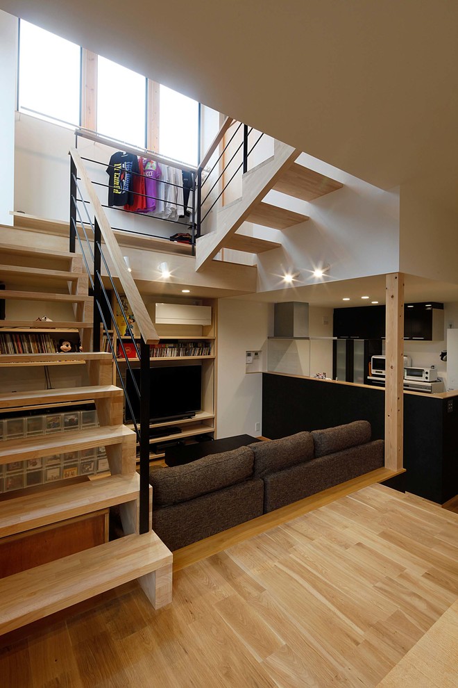 This is an example of a mid-sized country wood u-shaped staircase in Other with open risers and wood railing.