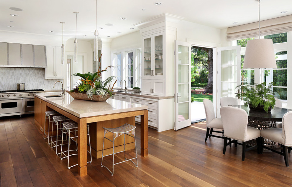 Example of a large transitional l-shaped dark wood floor and brown floor eat-in kitchen design in Miami with an undermount sink, shaker cabinets, white cabinets, multicolored backsplash, stainless steel appliances, an island and beige countertops