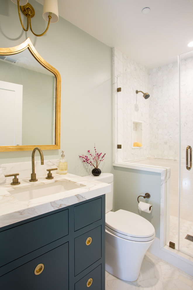 Inspiration for a small transitional 3/4 stone tile and white tile marble floor bathroom remodel in San Francisco with flat-panel cabinets, marble countertops, an undermount sink, blue cabinets, blue walls and a one-piece toilet