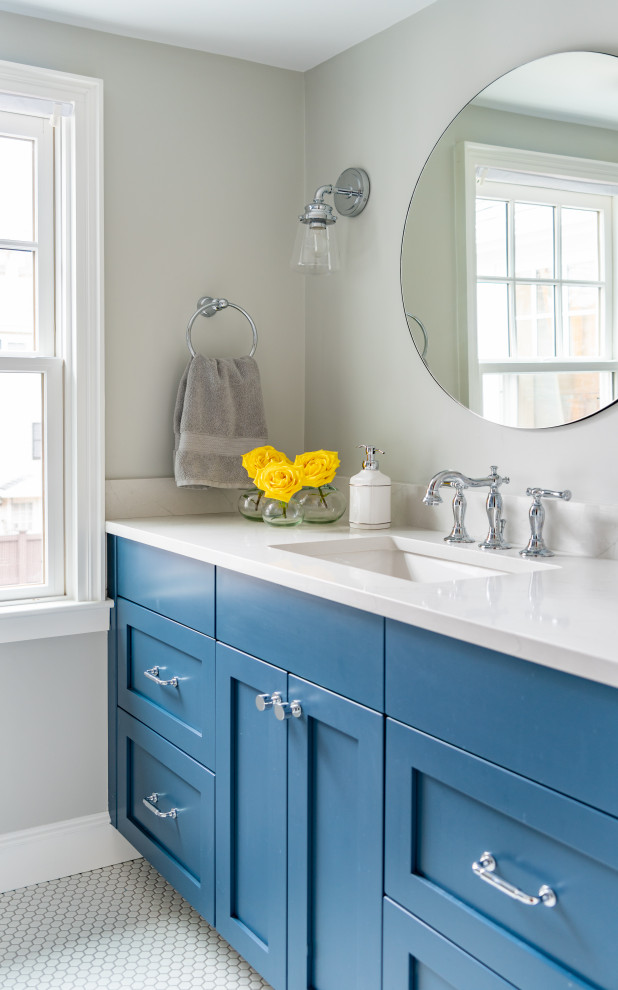 This is an example of a mid-sized traditional bathroom in Boston with blue cabinets, mosaic tile floors, an undermount sink, white floor, white benchtops and shaker cabinets.