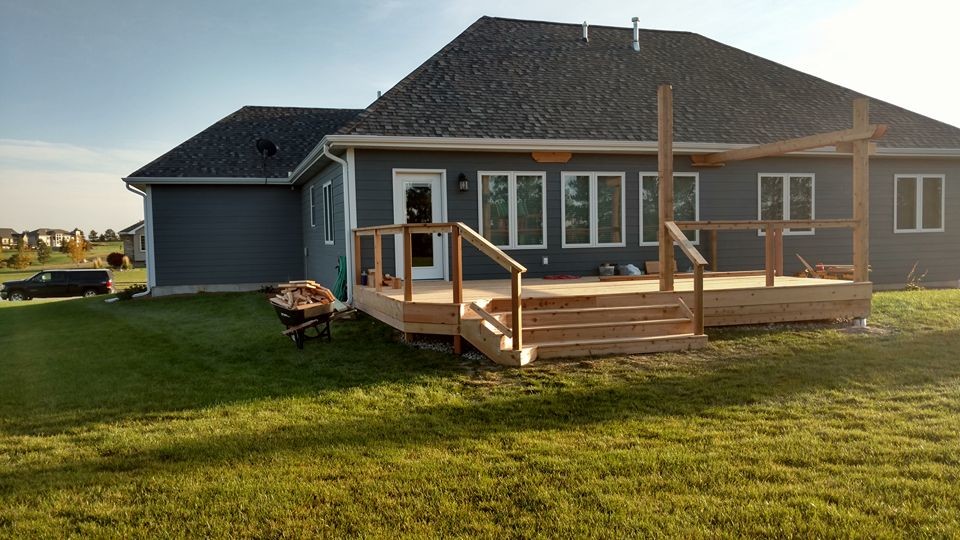 Inspiration for a large rustic deck remodel with a pergola