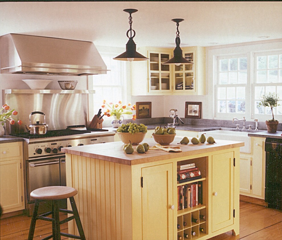Inspiration for a country eat-in kitchen in New York with a farmhouse sink, recessed-panel cabinets, white cabinets and stainless steel appliances.