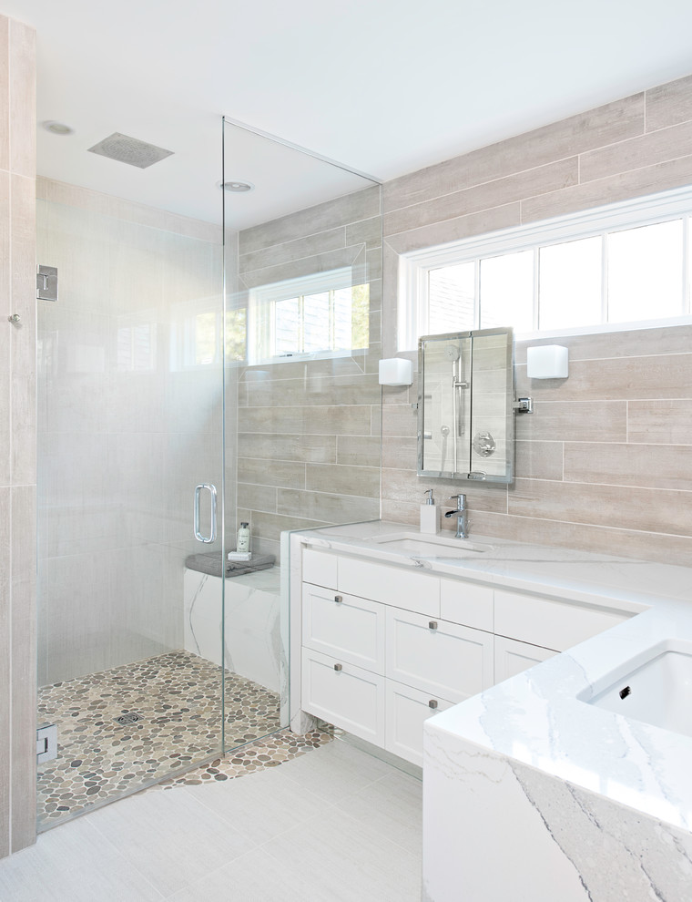 Design ideas for a mid-sized contemporary master bathroom in New York with recessed-panel cabinets, white cabinets, a curbless shower, gray tile, porcelain tile, grey walls, porcelain floors, an undermount sink, engineered quartz benchtops, white floor and a hinged shower door.