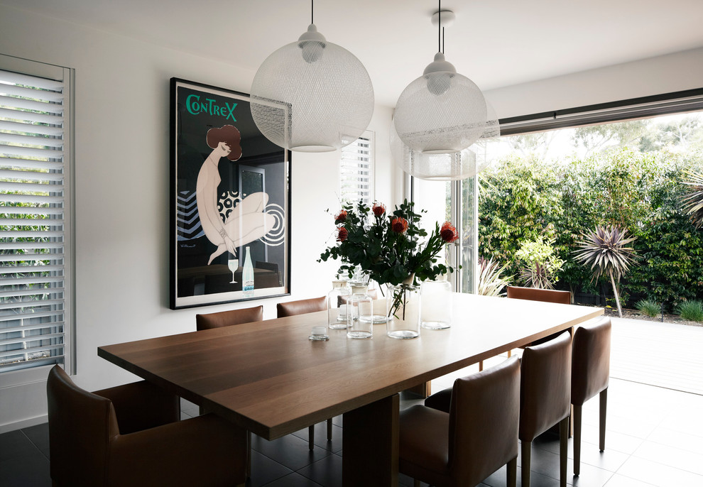 This is an example of a mid-sized contemporary kitchen/dining combo in Melbourne with white walls, porcelain floors and grey floor.
