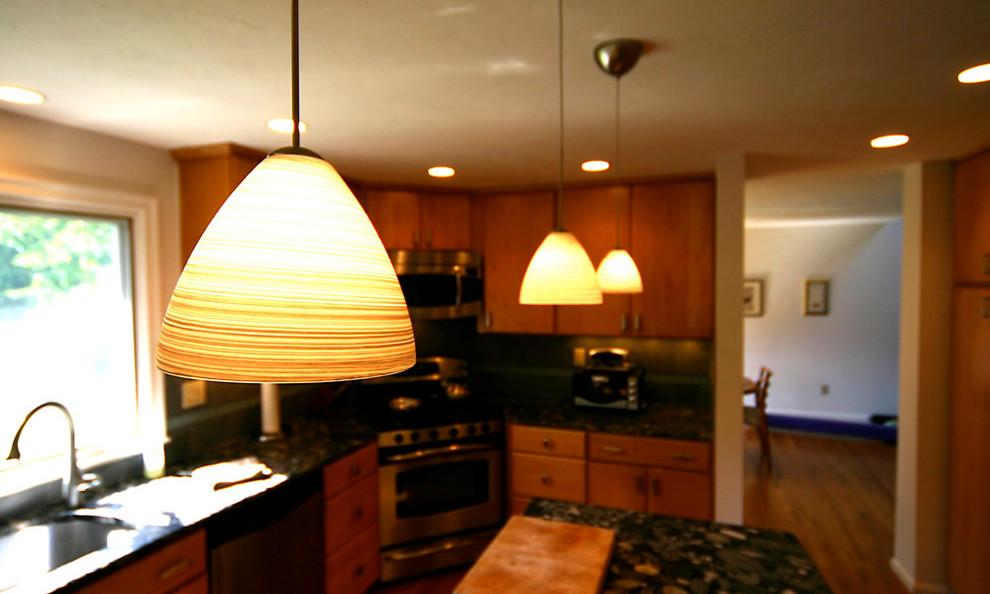 Mid-sized u-shaped medium tone wood floor kitchen pantry photo in Boston with an undermount sink, flat-panel cabinets, light wood cabinets, limestone countertops, gray backsplash, ceramic backsplash, stainless steel appliances and an island