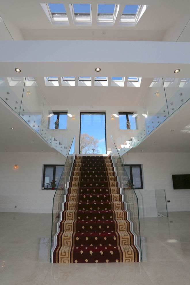 This is an example of a large mediterranean entry hall in Other with marble floors, white walls, a single front door, a red front door and white floor.