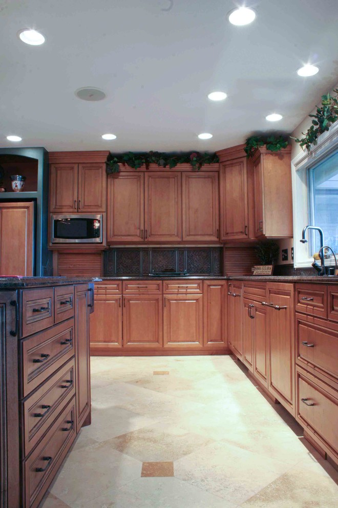 Inspiration for a large transitional l-shaped ceramic tile eat-in kitchen remodel in Seattle with an undermount sink, medium tone wood cabinets, granite countertops, beige backsplash, ceramic backsplash, stainless steel appliances and an island