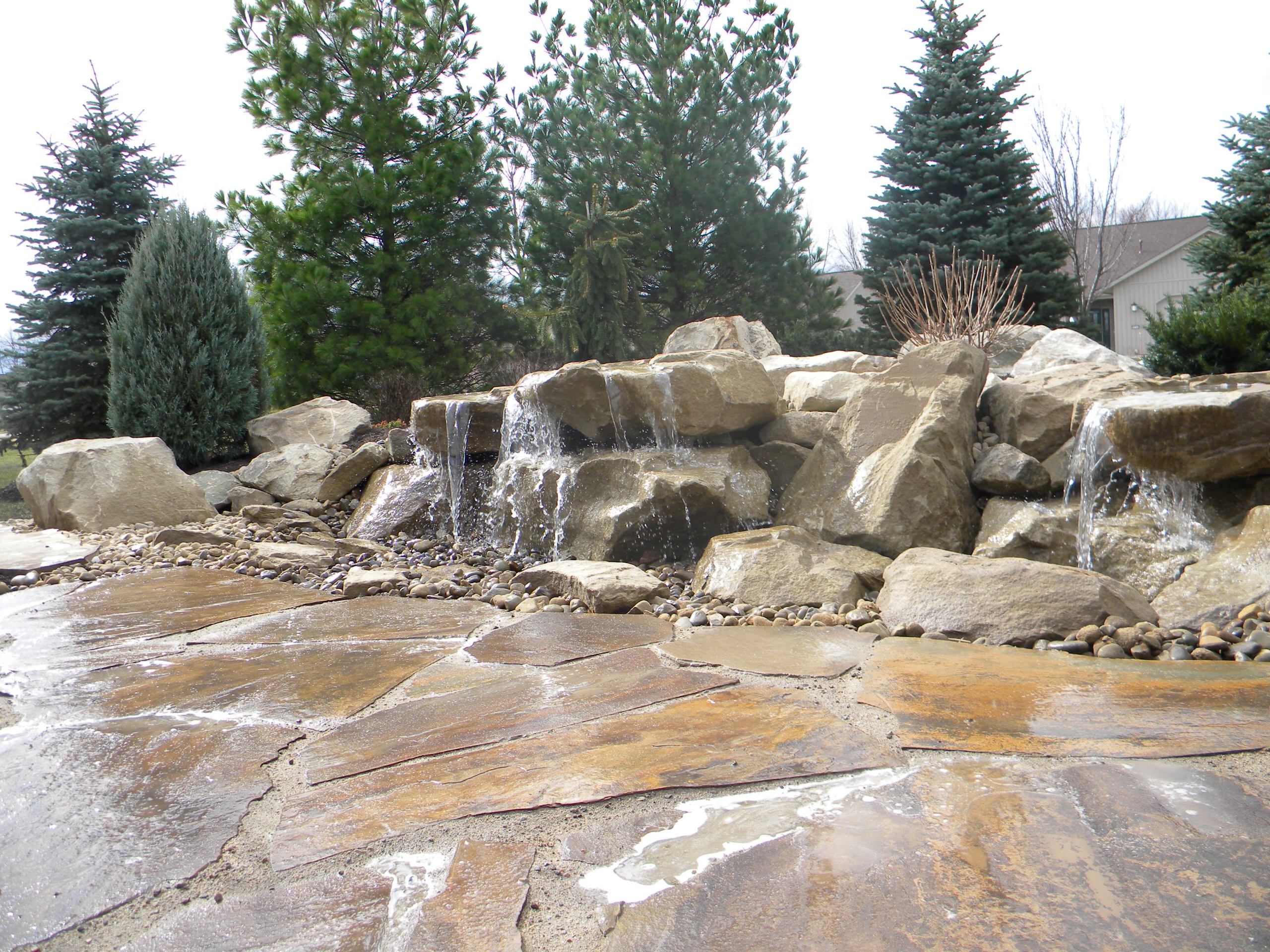 Carved stone water feature pondless and stone patio