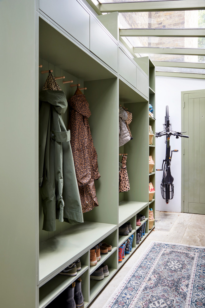 Photo of a small traditional mudroom in London with limestone floors, a single front door, a green front door and beige floor.