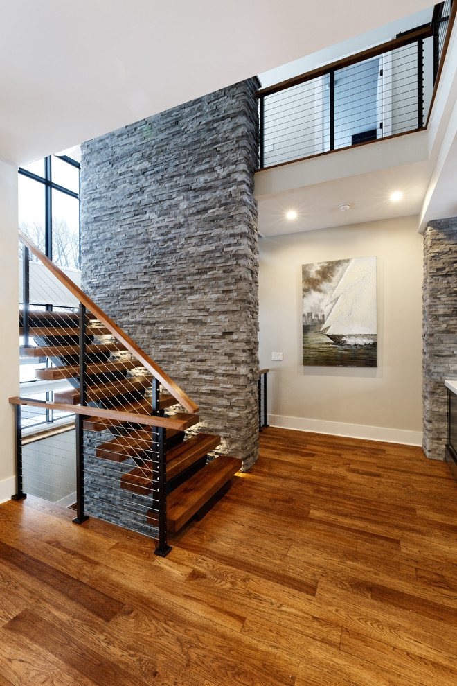 Photo of a contemporary wood u-shaped staircase in Cincinnati with cable railing and open risers.