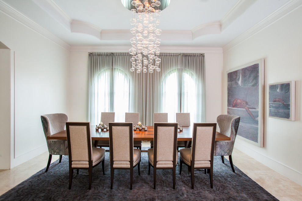 Contemporary separate dining room in Houston with white walls.