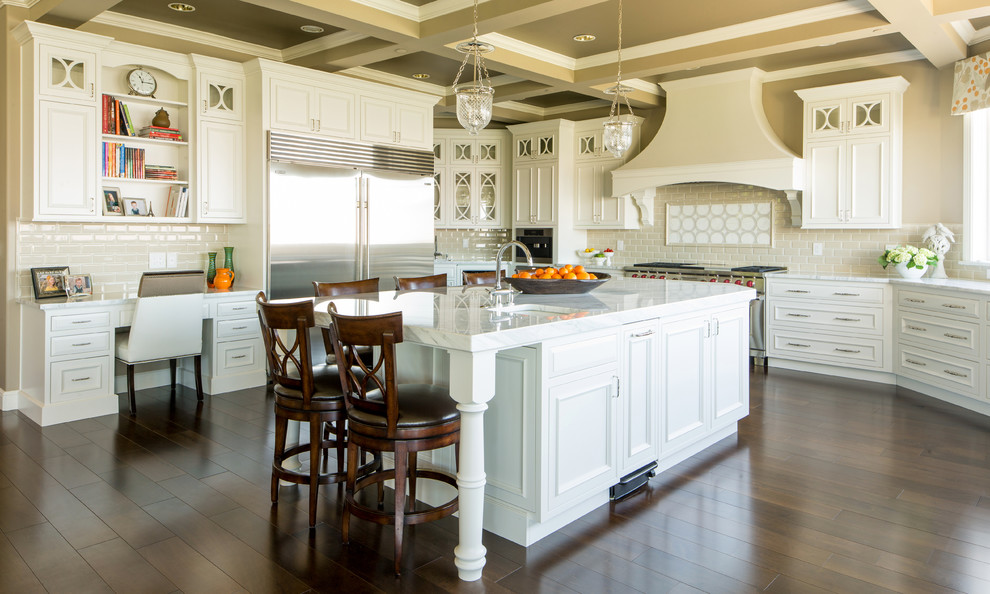 Huge transitional u-shaped dark wood floor open concept kitchen photo in Seattle with an undermount sink, beaded inset cabinets, white cabinets, marble countertops, gray backsplash, ceramic backsplash, stainless steel appliances and an island