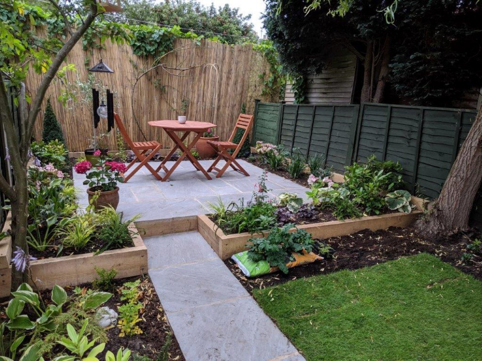 Small contemporary backyard shaded formal garden in Other with with privacy feature and concrete pavers.