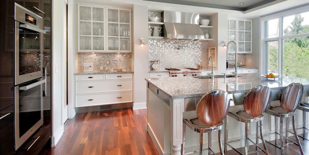 Example of a mid-sized transitional l-shaped brown floor kitchen design in Miami with an undermount sink, recessed-panel cabinets, white cabinets, quartzite countertops, glass tile backsplash, paneled appliances and an island