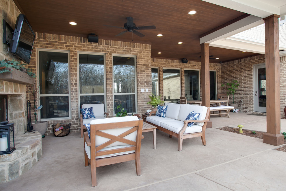 Design ideas for a mid-sized country backyard patio in Dallas with an outdoor kitchen, concrete slab and a roof extension.