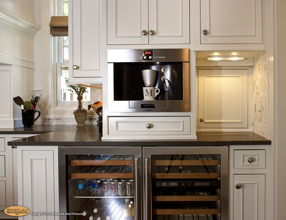Inspiration for a traditional l-shaped kitchen in Other with a farmhouse sink, flat-panel cabinets, white cabinets, stainless steel appliances, dark hardwood floors and with island.