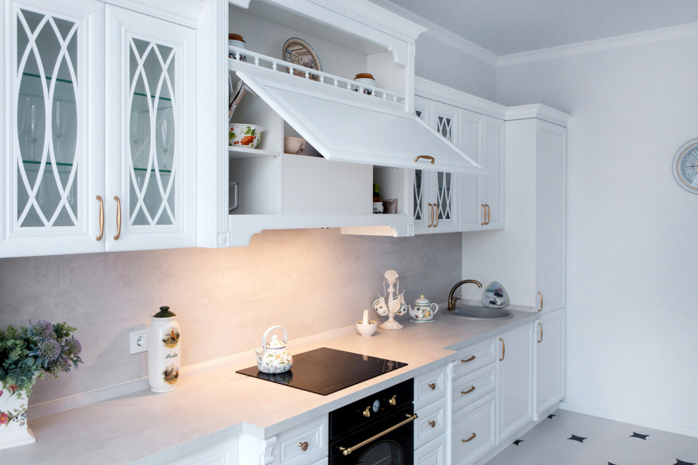 Design ideas for a medium sized traditional single-wall kitchen/diner in Other with a built-in sink, raised-panel cabinets, white cabinets, black appliances, ceramic flooring, white floors and grey worktops.